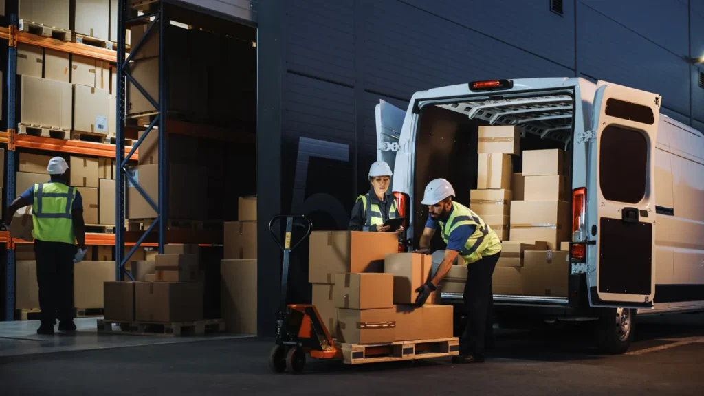 Outside of logistics retail warehouse with Inventory Manager using tablet computer