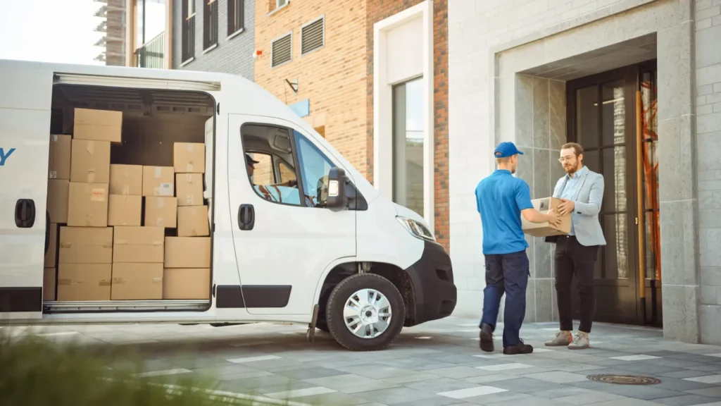 A delivery man receving packages